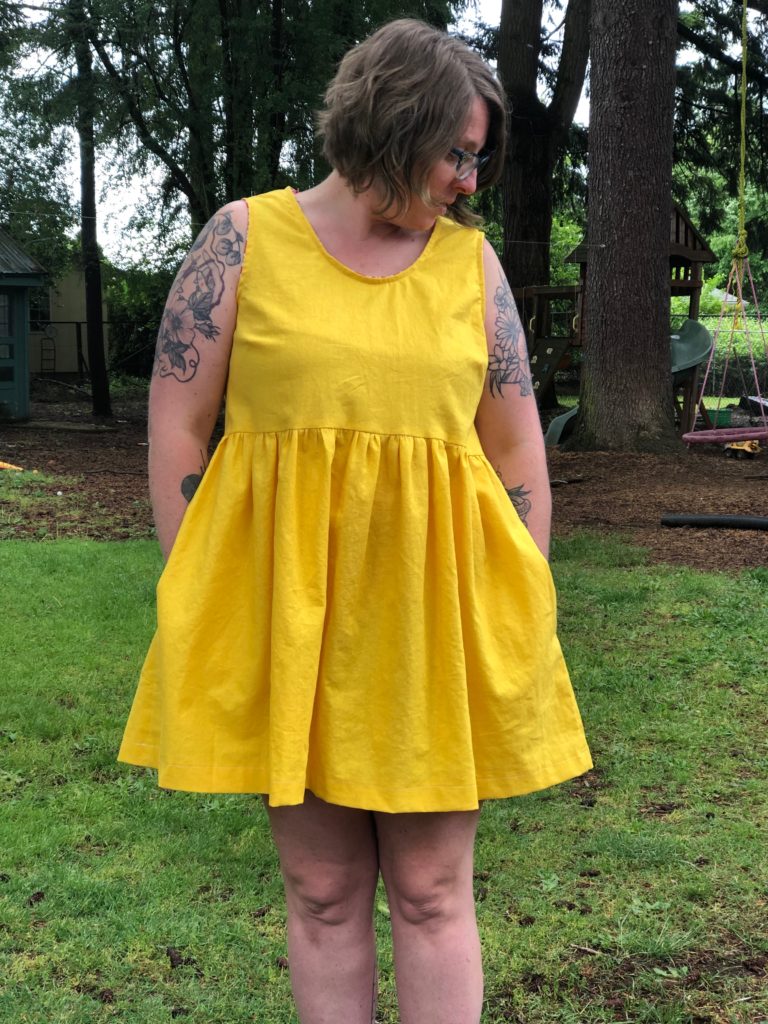 A front shot of me, a white lady, with a me-made bright yellow party dress on