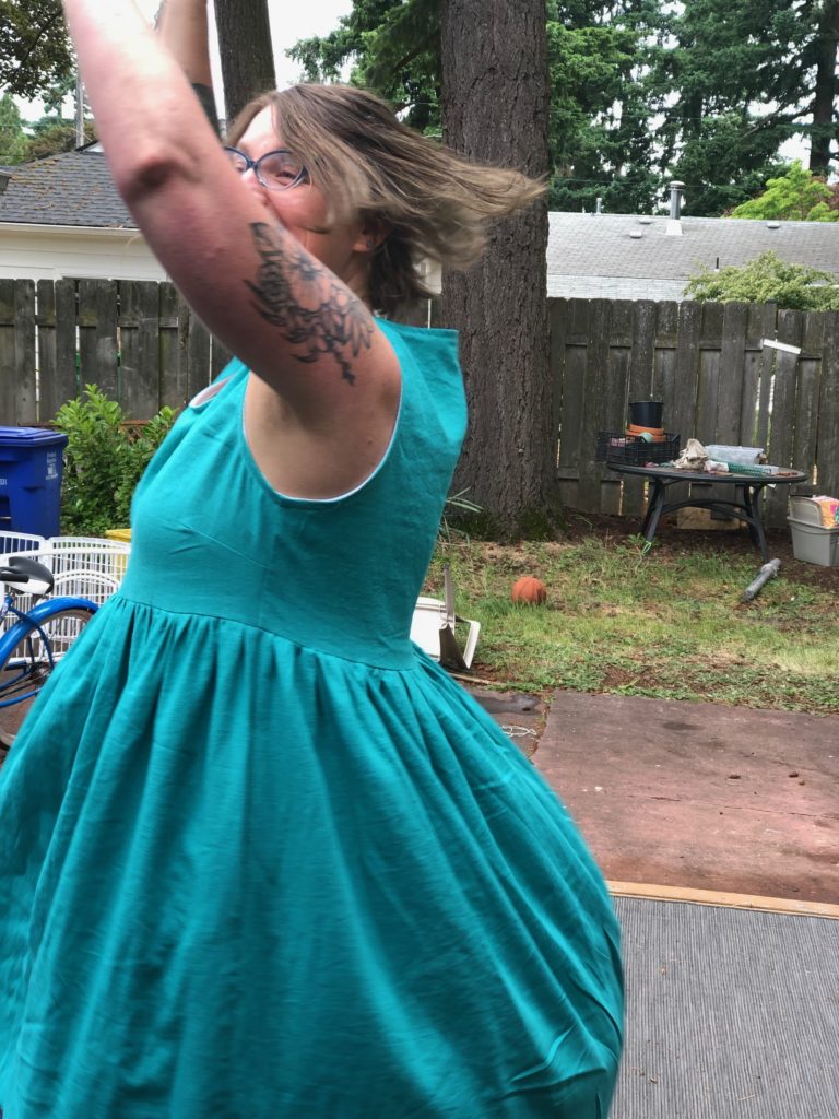 I am spinning in my new dress, with lots of joy on my face