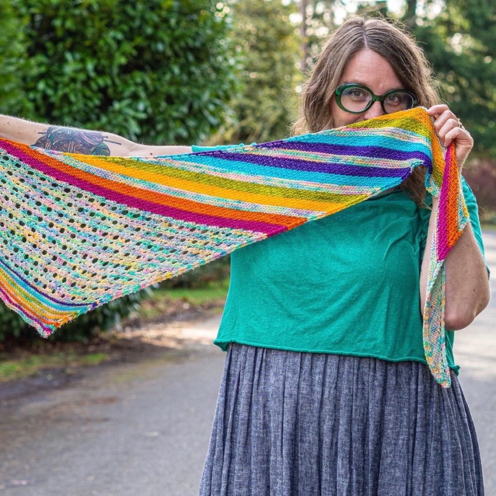 magically chromatic shawl held out to show shape and patterning